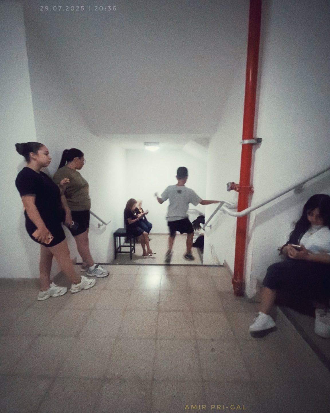 Capturing a moment of suspended reality inside a mall's protected space during a missile alert... the surreal juxtaposition of ordinary life interrupted by a moment of danger. The people illuminated by sterile overhead light, exist in a quiet state of limbo, displaying a mixture of anxiety and practiced calm. A resilience and a normalization of crisis in contemporary life.
#israel #reallife #photojournalism #storytelling #life #people #hope #peace #photography #ProtectedSpace #SurrealReality #LifeUnderAttack