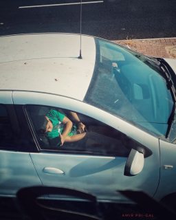 The story is unclear, a quiet scene framed by the car window. A boy's head is bowed—is he sleeping, lost in thought, or just counting on his fingers? Beside him, only his mother's hands are visible. Are they a sign of comfort, of patience, or of silent worry about her son's situation? A private moment on a public road, a snapshot of either simple, normal life or something much deeper. Captured at 8:45 AM, on a day like any other.
#UnspokenStories #MotherAndSon #AQuietMoment #CandidFamily #WhatsTheStory #HandsTellAStory #LifeInAMoment #IntimateScapes #StreetPhotography #israel
