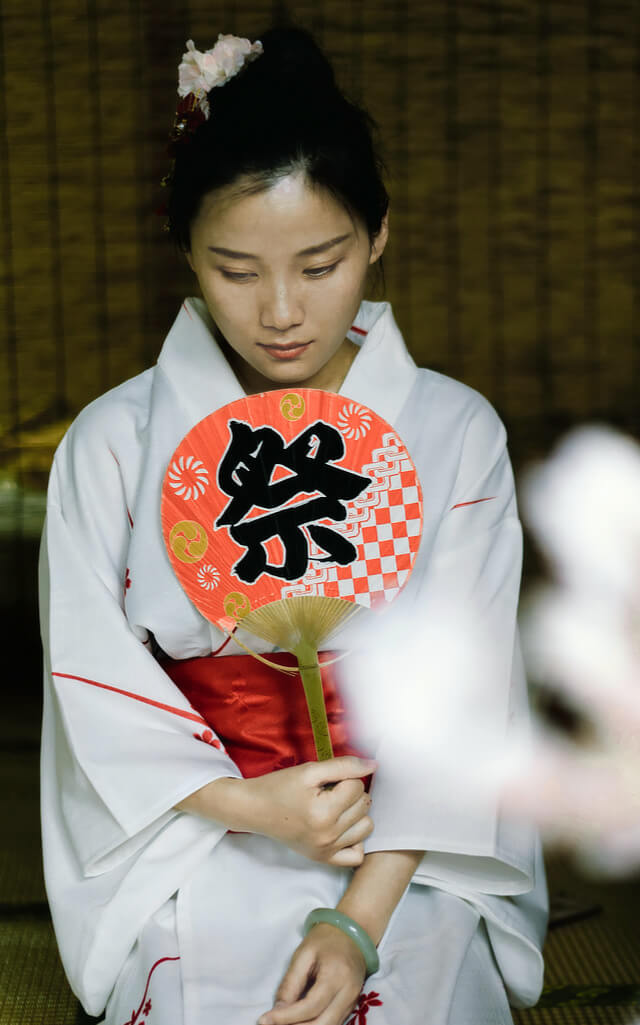 woman in a kimono with a fan