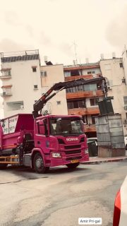 In a residential urban setting, a garbage truck engages in the essential rhythm of city life, retrieving a heavy bin from its underground repository. The powerful, often underspoken, systems that maintain the order and cleanliness of our communities quietly performing their vital tasks after a rainy morning.

#UrbanPhotography #CityLife #FindingBeauty #EverydayIsrael #StreetPhotography #Scania #UrbanMachinery #TheColorOfWork #DailyGrind #Cityscape #UndergroundWaste #PostRain #CityRhythms